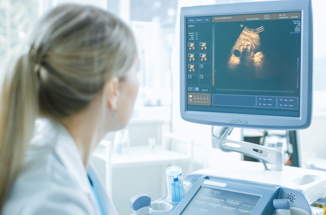 Radiologist interpreting a patient's ultrasound at the bedside